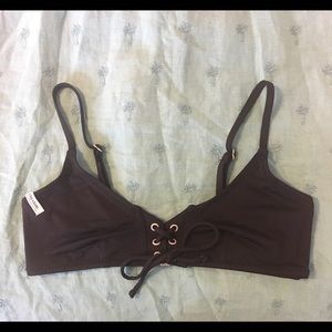 Black lace-up bikini top by Rhythm Swimwear